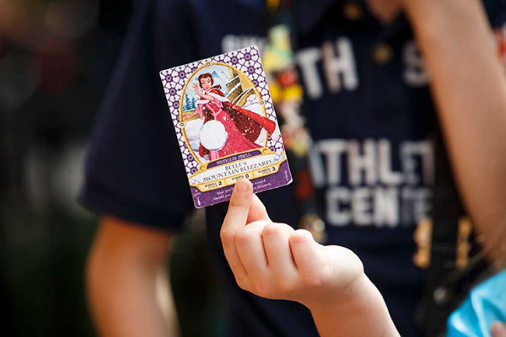 A guest casts a spell with a Sorcerers of the Magic Kingdom card during an interactive game that allows players to battle the likes of Cruella, Jafar, Ursula and Scar at Walt Disney World's Magic Kingdom.