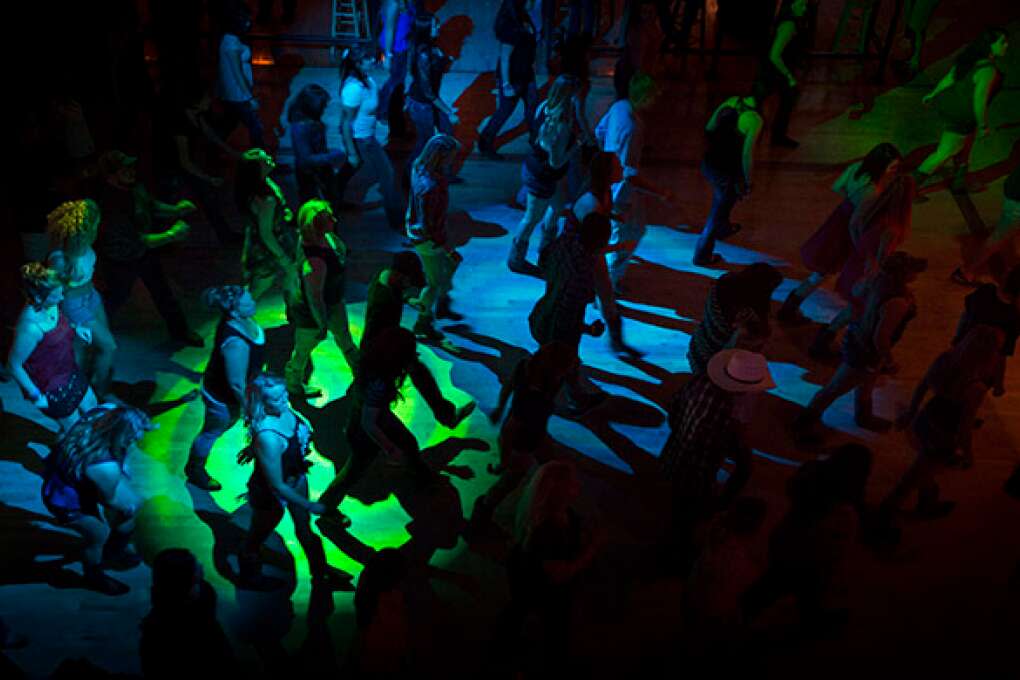 The floor is packed during a line dance at the Dallas Bull in Tampa, where on most nights the line to enter wraps around the building.