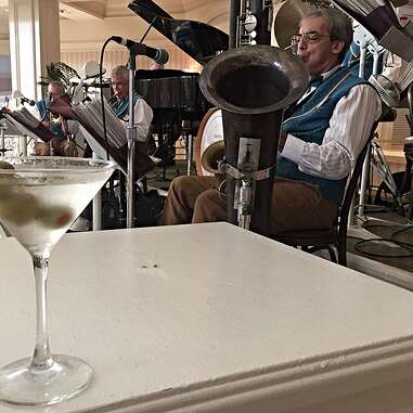 a jazz band playing live music next to a martini cocktail at the bar