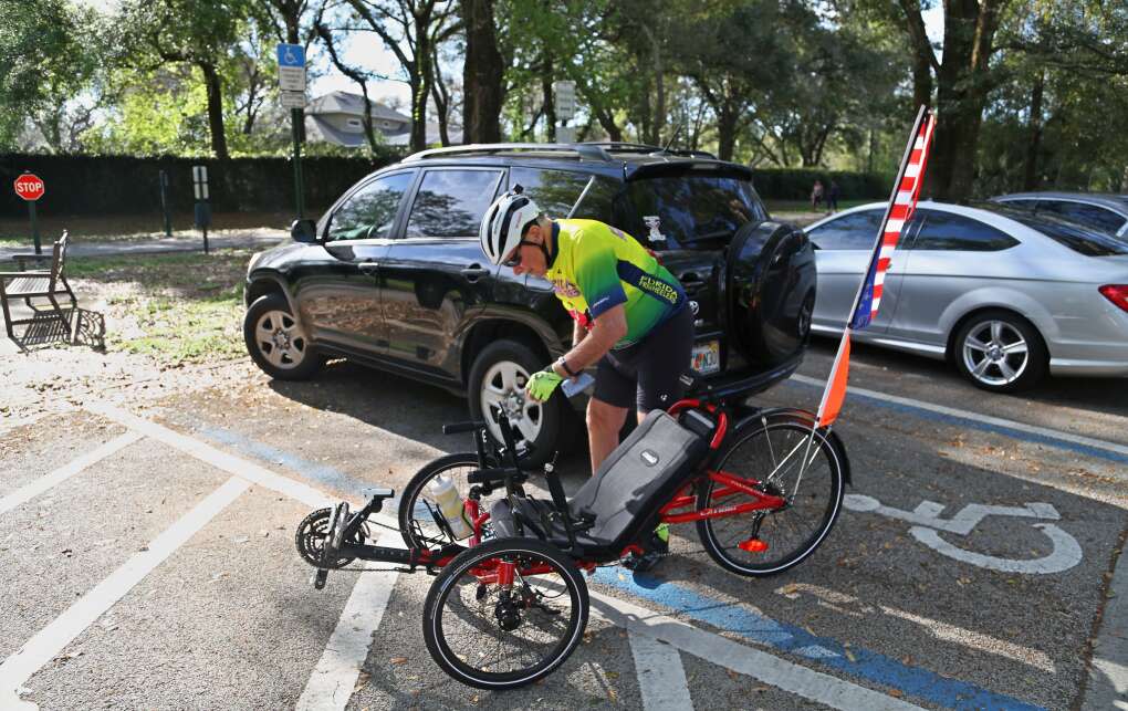 Cyclist Phil Mings, 77, Winter Springs, prepares his recumbent bicycle for a ride on the Seminole Wekiva Trail at the Jones Trail Head.