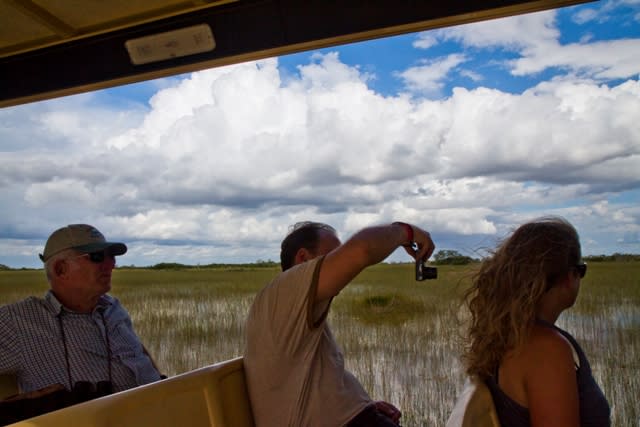 Tourists taking pictures of the Everglades National Park on board of the tour truck