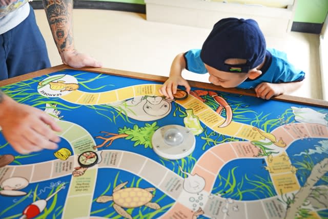 A kid playing a game board at Indian River Lagoon