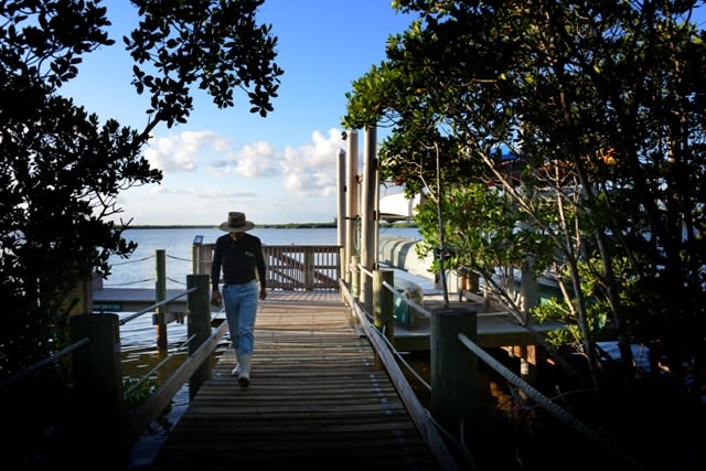 A man walking by the docks at Indian River Lagoon