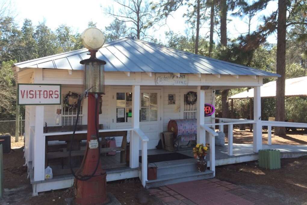 A white old cabin welcoming guests