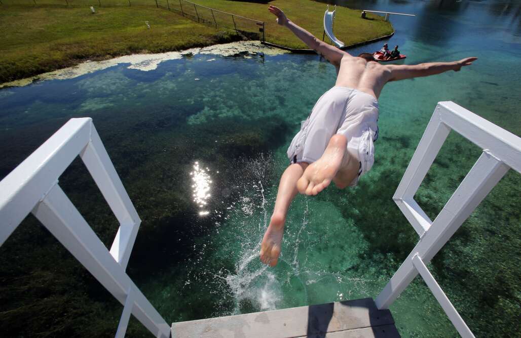 diving from a platform into Florida's Vortex Spring