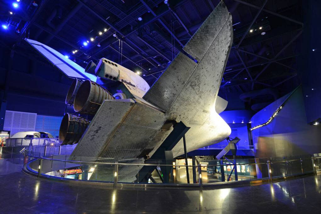 Atlantis sits atop two steel columns, but gives the appearance it’s floating in space, tilted at a 43-degree angle with landing gear down.