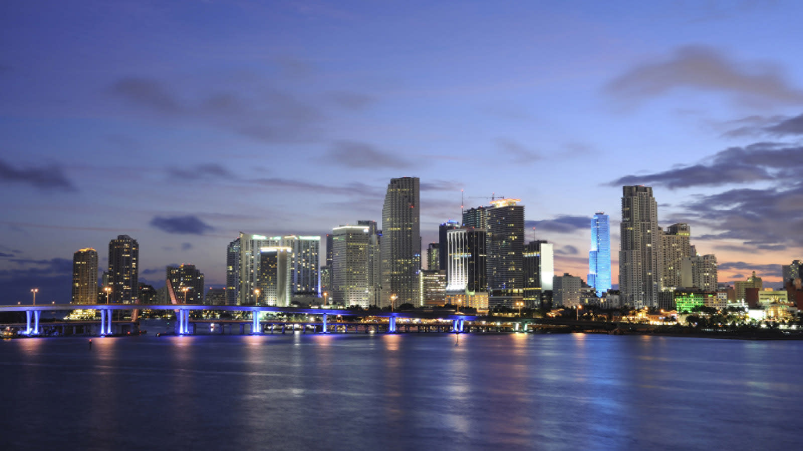 The beautiful skyline of Miami at night with blue lights
