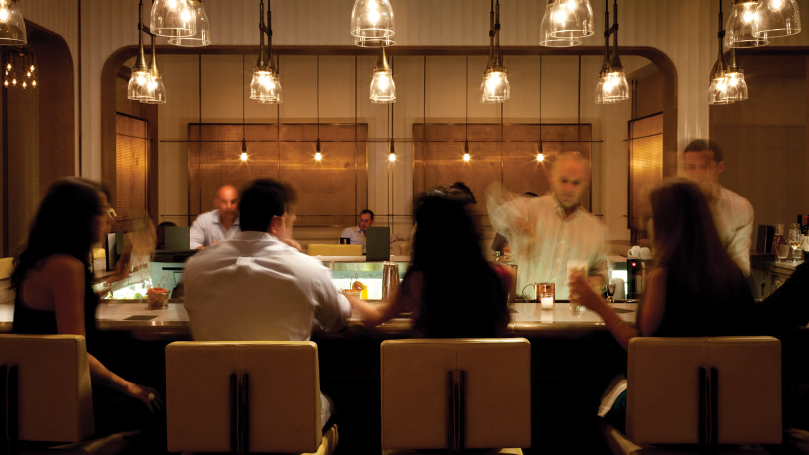 People having drinks around the bar at the EDGE Steak & Bar