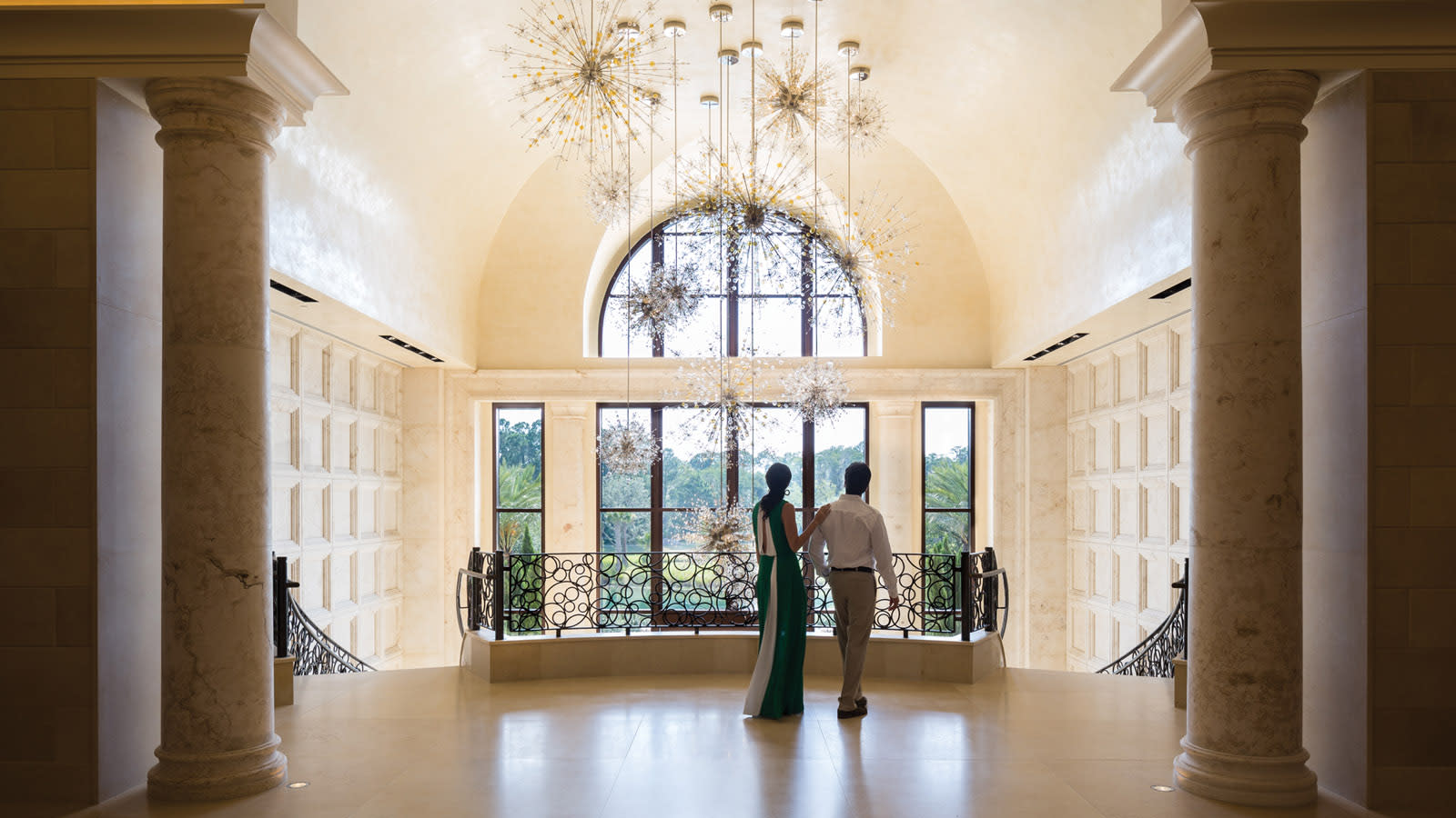 A couple admiring the big chandelier at the Four Seasons Hotel & Resort