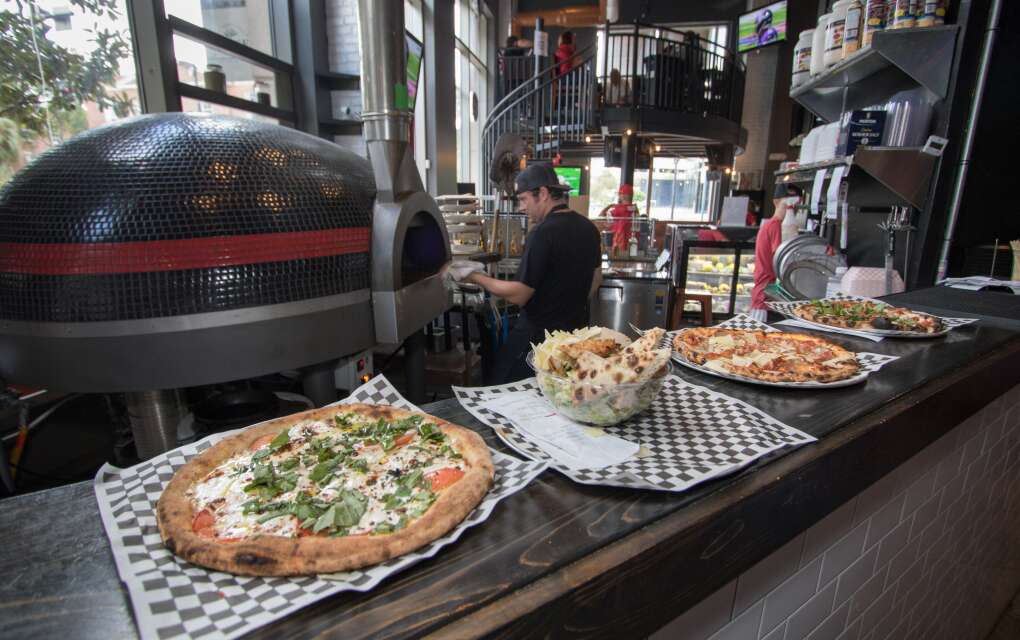 The Market on Magnolia food hall in downtown Orlando features three local eateries, including 081 Wood Fired Pizza. 