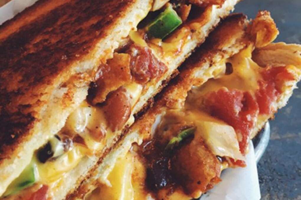 Ms. Cheezious, a former food truck in Miami, loads its version of the grilled cheese with its own chili, American cheese, jalapeños, onions and Fritos. The sandwich is grilled between two slices of crispy sourdough that keeps all the stuff intact.