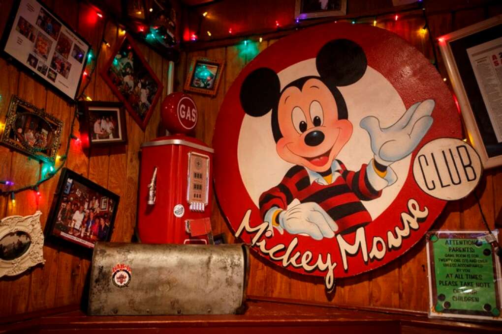 A vintage Mickey Mouse Club sign is part of the eclectic décor at Johnny’s Fillin’ Station in Orlando.