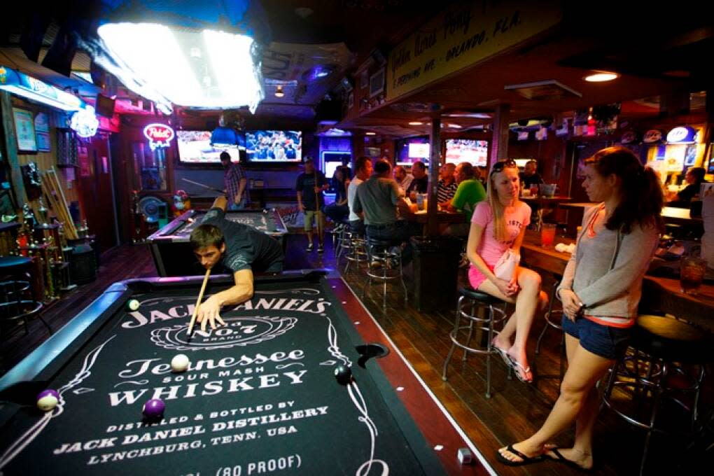 Guests at Johnny’s Fillin’ Station can play pool on two pool tables amongst the eclectic décor, which includes trophies from various local youth sports teams in Orlando.