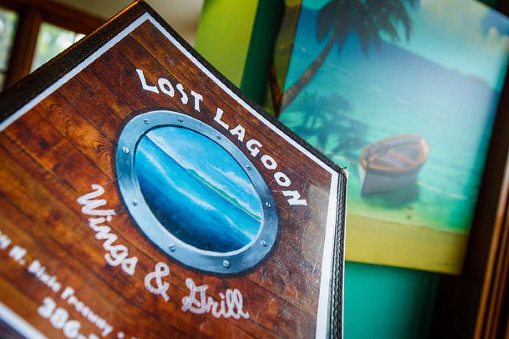 The painted porthole scene on the sign at Lost Lagoon Wings & Grill in New Smyrna Beach hints at the tropical vibe inside.