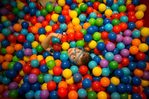 Evan Moda, 4, lays a bin of balls at the Glazer Children's Museum during Sunshine Sunday for special needs children in Tampa.