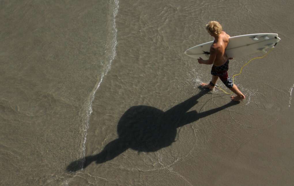 A surfer prepares to brave the waves. Cocoa is a renowned among the hang-ten crowd, and even features an independent gallery showcasing surfer artwork. 