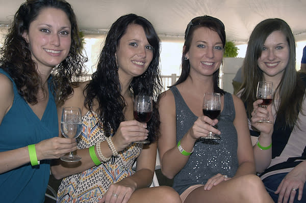 Four women enjoying the Wine Tasting Pavilion at the Swiss Wine Festival.. Photo by Kendal Miller.