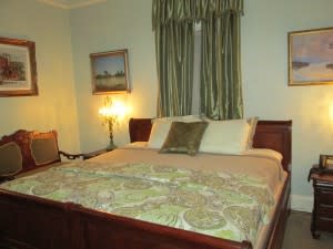 The Lawton Room at Sion House is decorated in soft greens and antique furniture.
