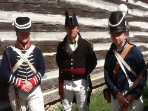 Re-enactors wear costumes reflecting military life.