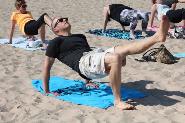 That's the author trying beach yoga. It was an intense workout, but fun.