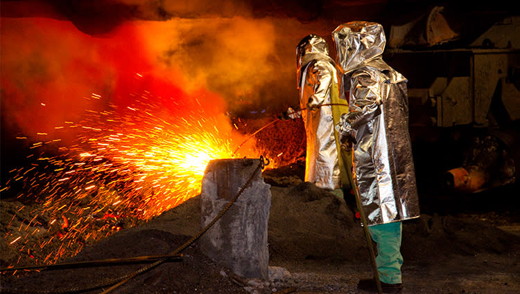 people working at a blast furnace