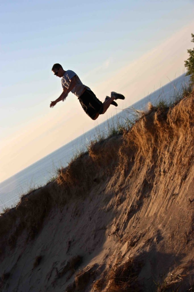 a man jumping in sand