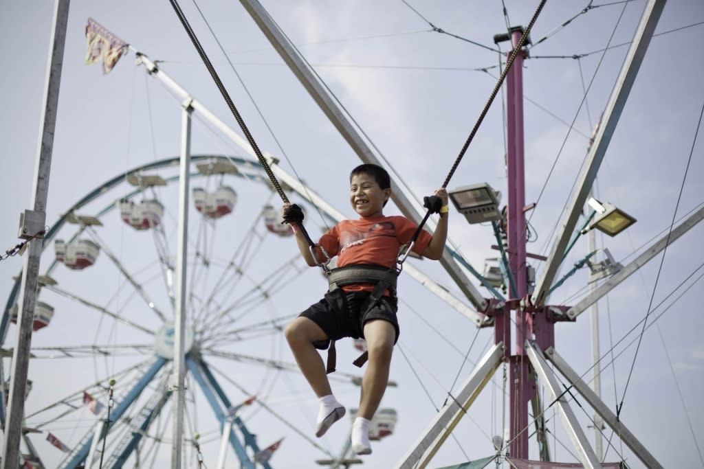 a boy on an amusement park ride