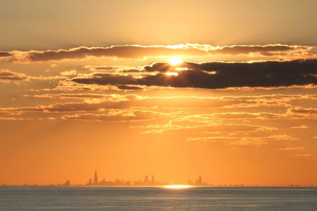 Chicago skyline across Lake Michigan at sunset