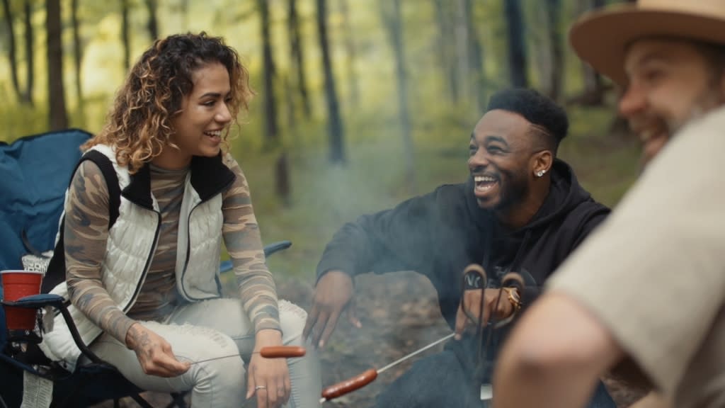 people laughing around a campfire at Indiana Dunes