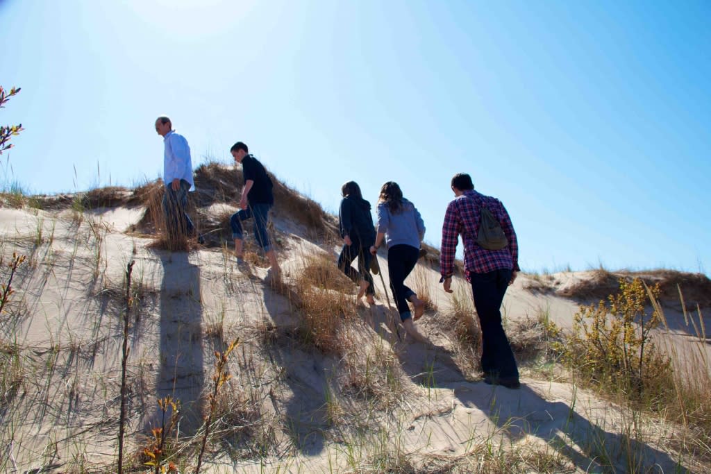 people hiking the dunes