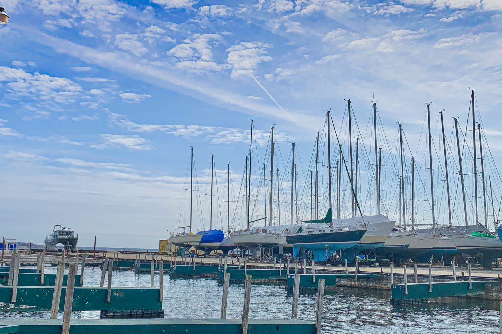 sailboats at marina are docked in front of open slips