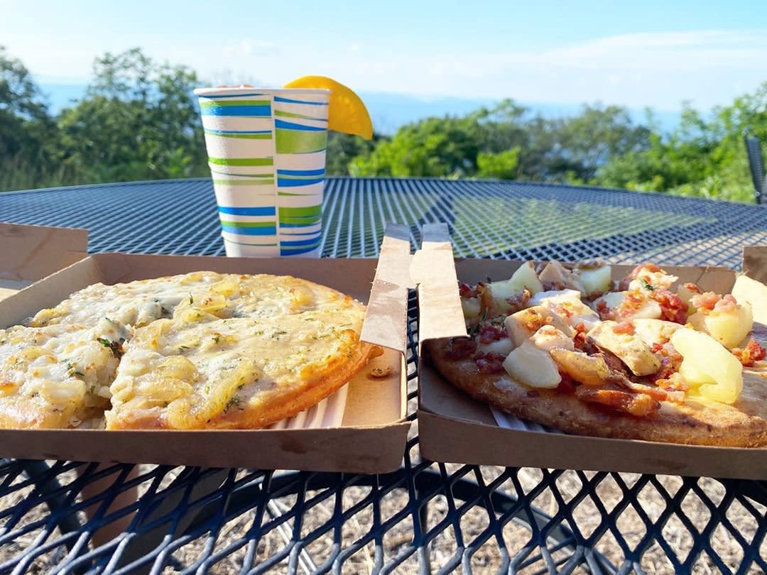 Photo by user deity.dreams, caption reads Personal pizzas and cocktails with a view of @shenandoahnps..#bigmeadows #skylinedrive #shenandoahnationalpark #ohshenandoah #bigmeadowslodge #pizza #views #dateday