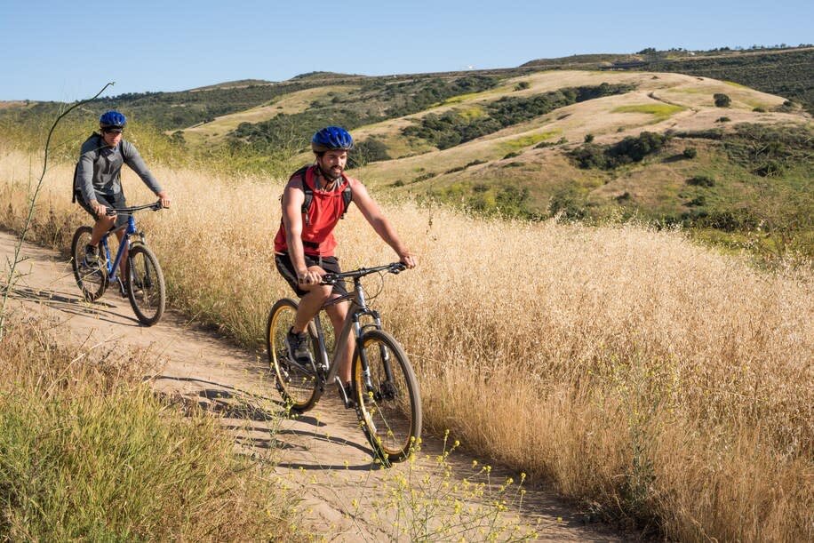 Two bikers on a trail in Irvine, Calif. The city’s open space offers miles of trails for mountain biking, hiking and trail running.