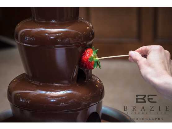 We Do Fondue strawberry dunked in chocolate fountain