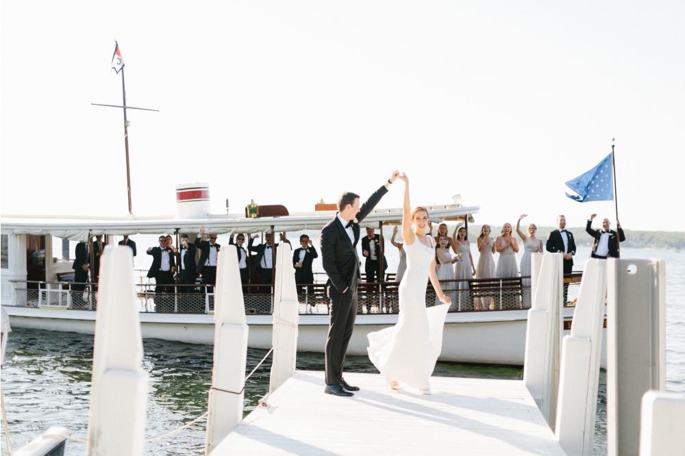 Groom Spins his Bride as their Bridal Party Cruises Behind them Cheering!