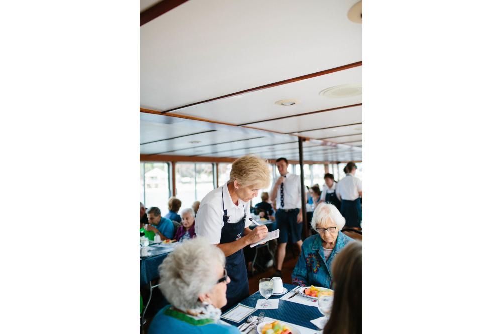 Waitress taking drink orders on board the Grand Belle of Geneva on Lake Geneva