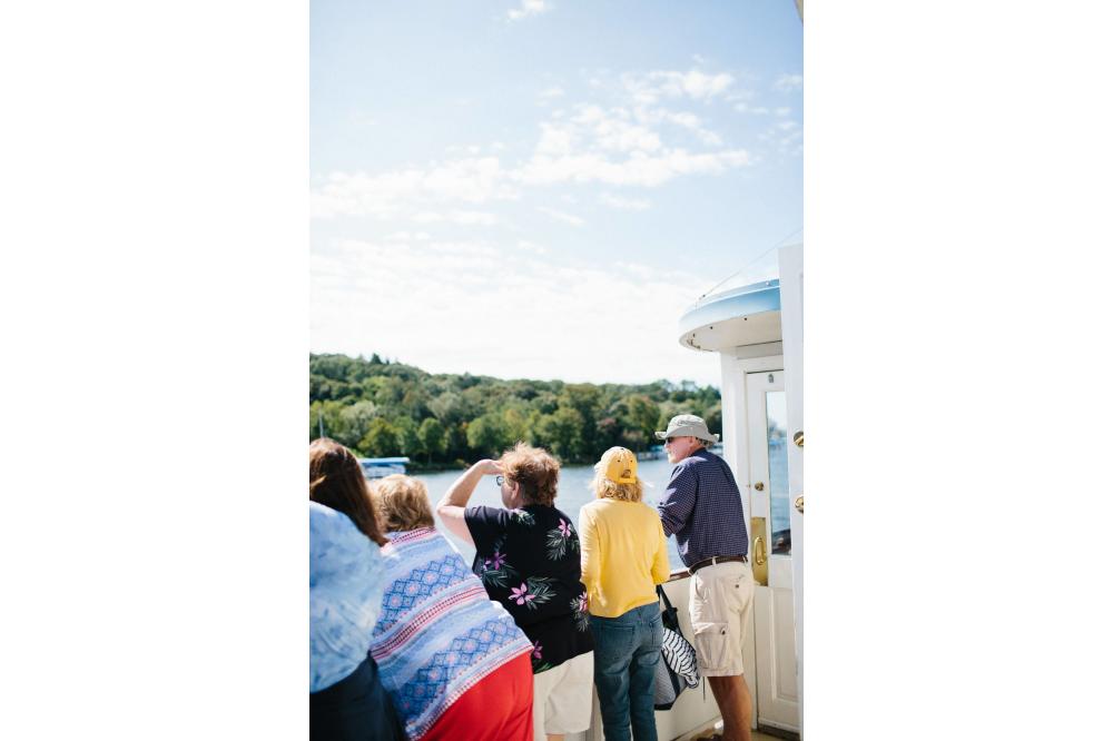 Group of Tourists look at the estates along the shoreline