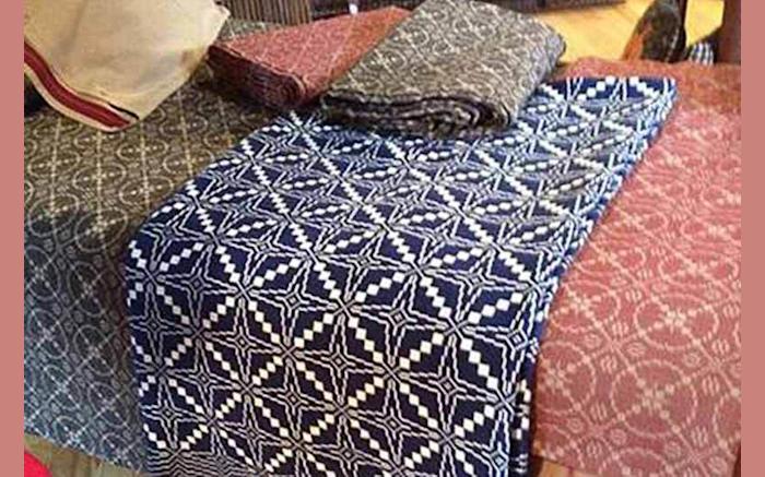 Coverlets displayed on an Antique Bed