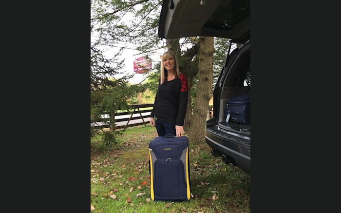 Angela loading luggage into vehicle