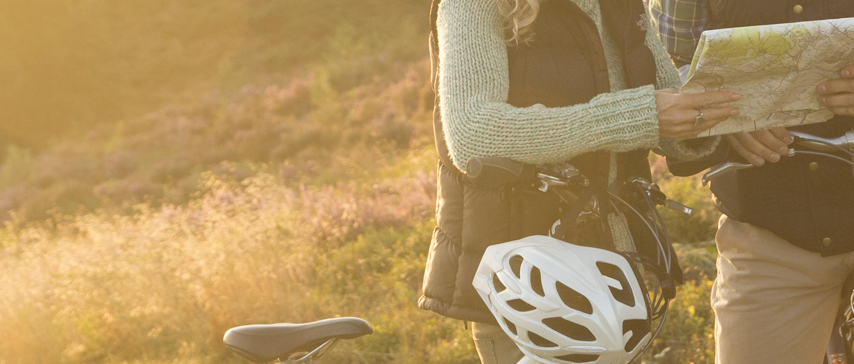Cannock Chase heathland Autumn sunshine couple on bikes stopping to read map