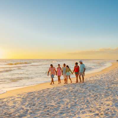 Family walking along Sombrero Beach in Marathon Florida. FloridaKeysVillas.com
