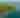 Aerial view of a lush green forest atop rocky cliffs bordering the clear blue waters of Lake Superior. The peaceful scene conveys a sense of tranquility and natural beauty.