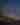 desert landscape with a saguaro cactus, desert brush, and a night sky filled with stars