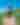 Pristine blue sky, green prairie foreground, man with cowboy hat seen from the back riding horse.