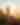 Hiker on a rock enjoying sunrise with hands up