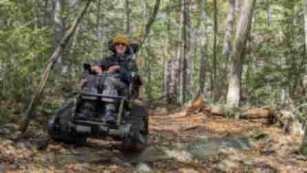 A person wearing a yellow knit cap uses an Action Trackchair to go hiking in the Catskills with Northeast Off-Road Adventures