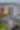 A drone shot of Waterway Square with particular focus on The Westin, a long, white building with even rows of blue-tinted windows. There is a flower mural on the building behind it, The Waterway stretches from the viewer toward The Woodlands Towers in the background.