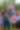 Four young adults (a woman, two men, and another woman)  smile for the camera. They're all dressed in elaborate red, white, and blue summer ensembles--complete with fake floral leis, bead necklaces, sunglasses, and rhinestone face art.