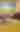 Two girls sit atop thousands and thousands of yellow corn kernels in an enclosed corn pit.