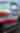 A classic car is painted to look like an American flag